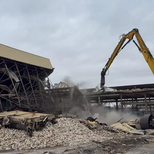 Demolition excavator removing commercial building, HammerCore Group demolition services.