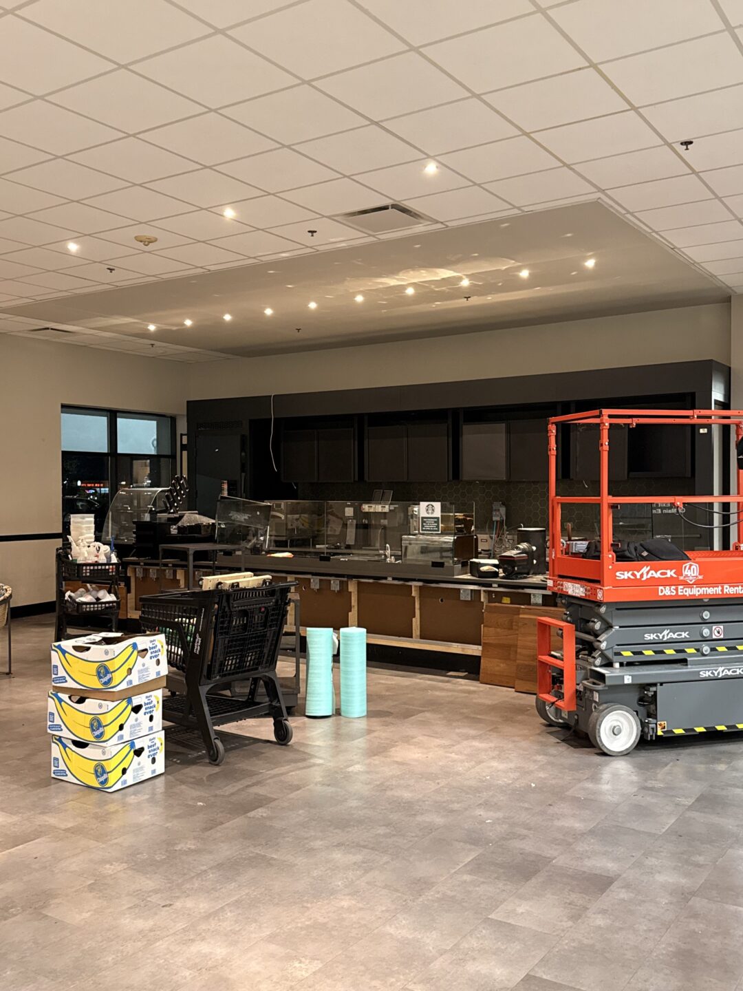 Commercial interior remodeling project with construction equipment and cafe elements.