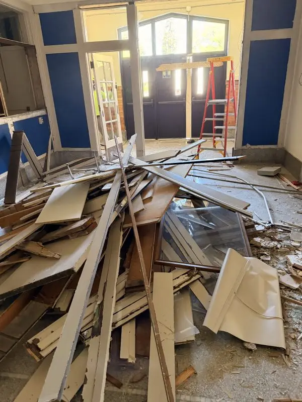 Commercial demolition debris and building materials in a renovated space.